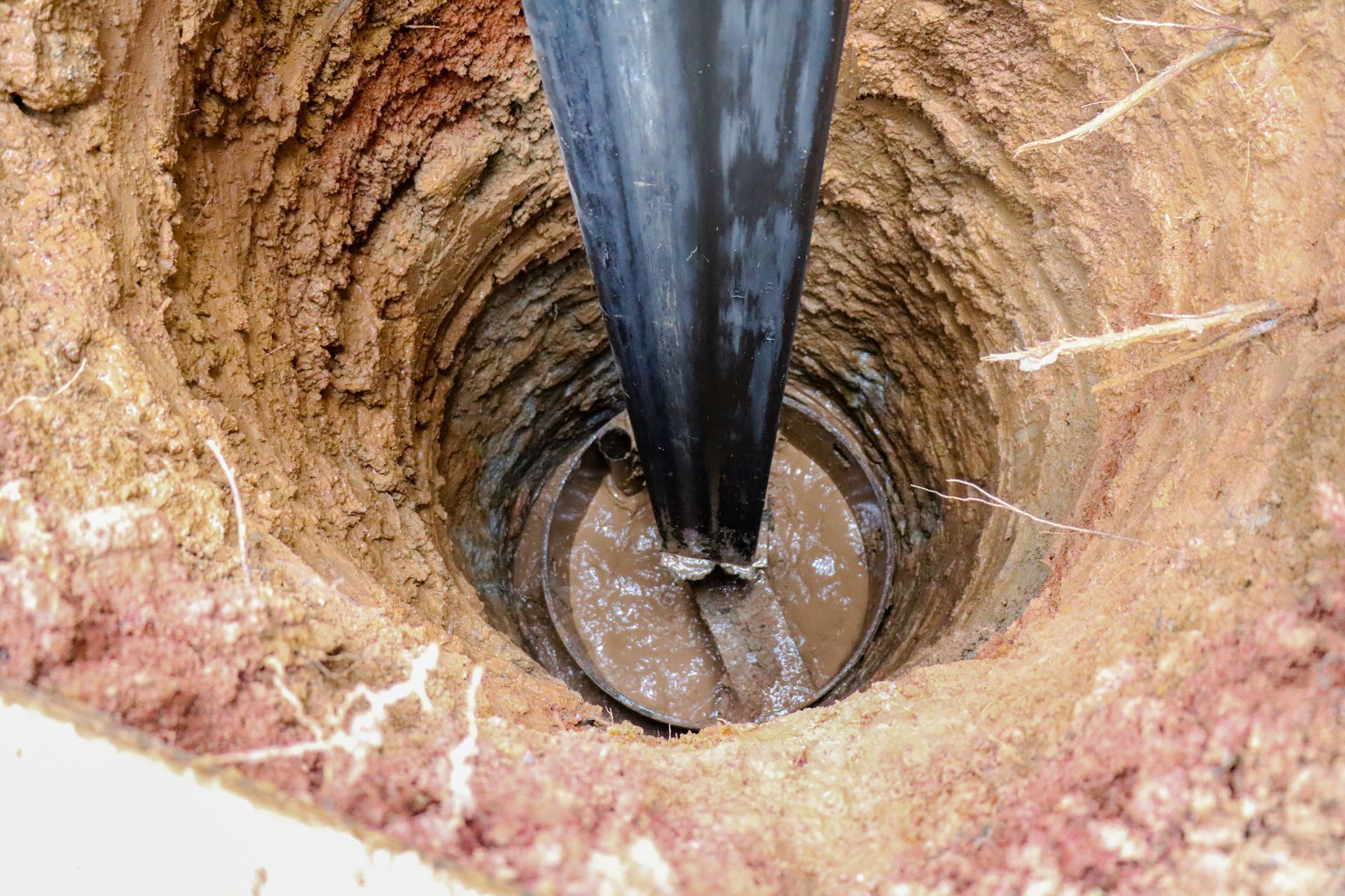 A hole in the ground made by a drilling rig machine, for well-drilling services.