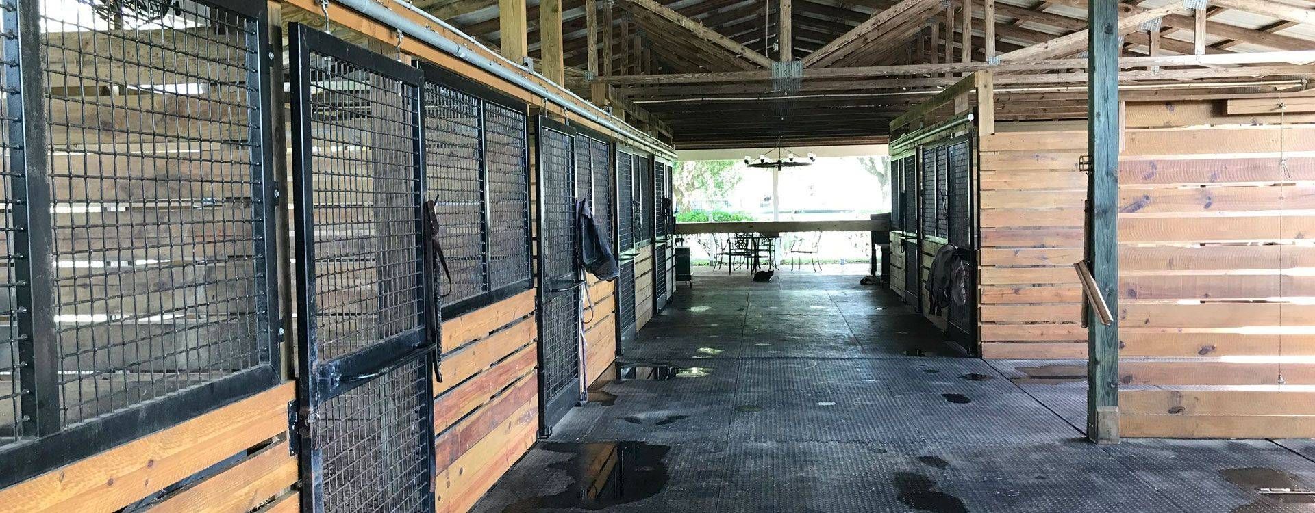 the inside of a barn with wooden walls and metal fences