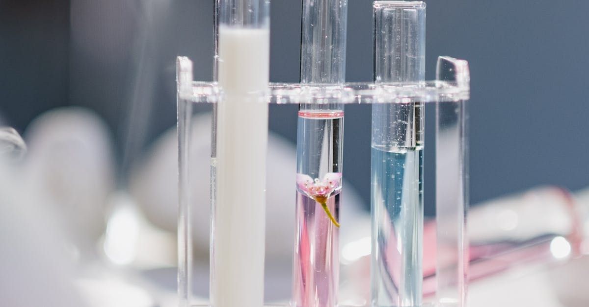 A row of test tubes filled with different colored liquids on a table.