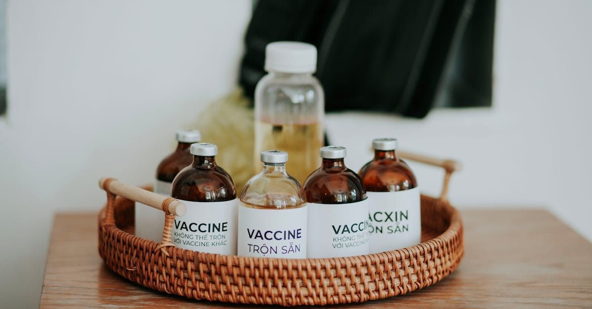 A wicker tray filled with bottles of vaccine on a wooden table.