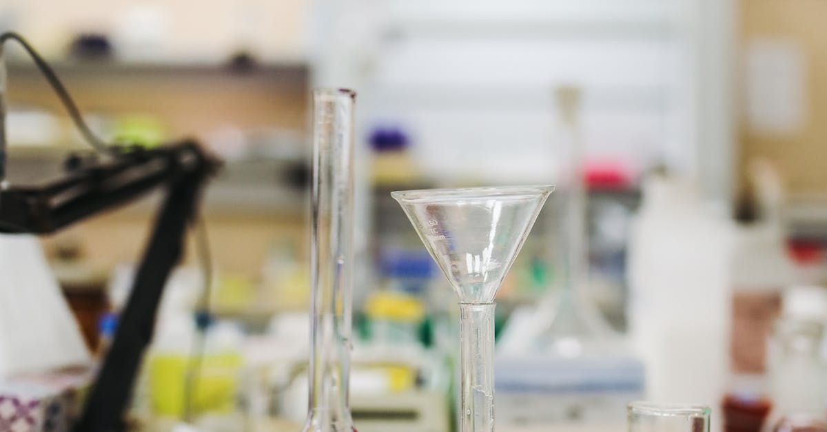 A blurred image of a laboratory with beakers and test tubes on a table.