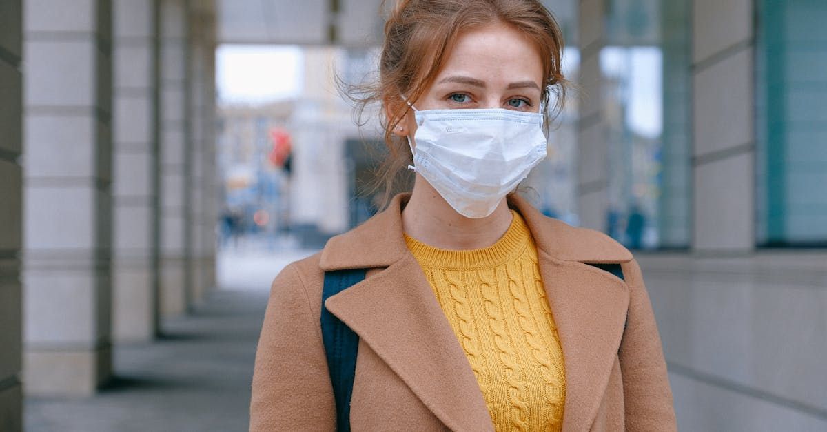 A woman wearing a face mask is walking down the street.