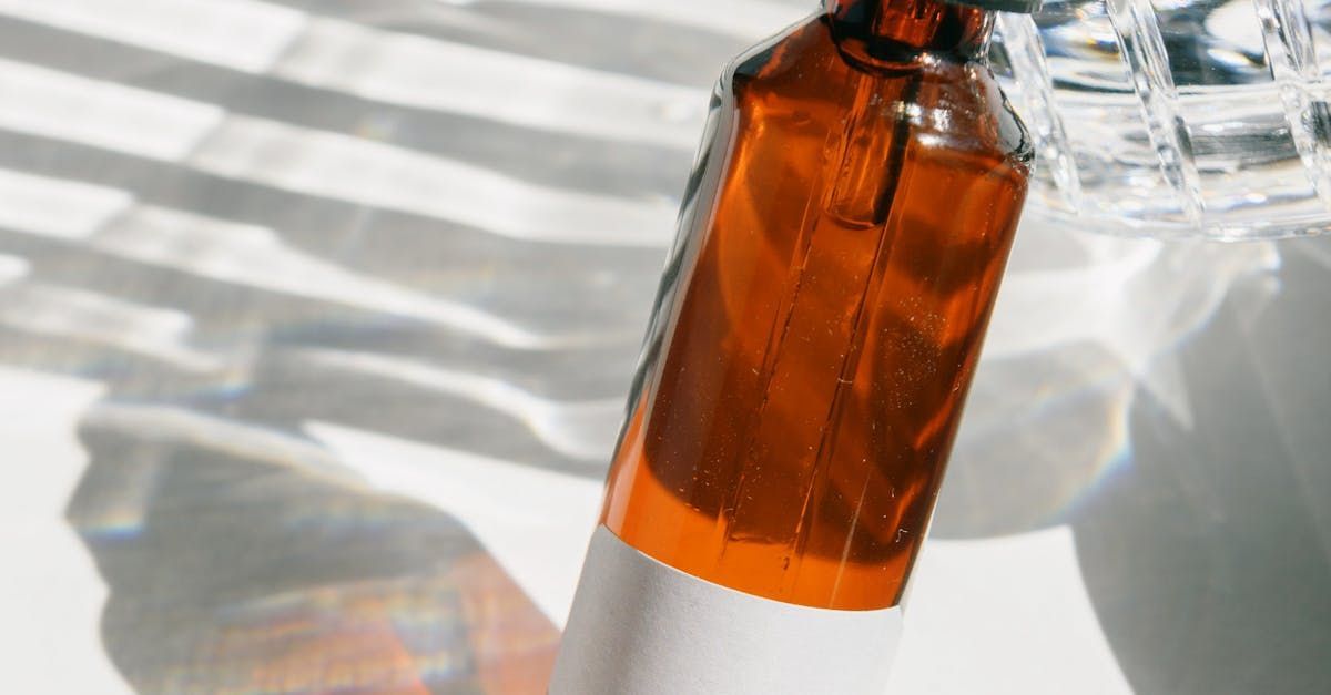 A close up of a bottle of liquid on a table.