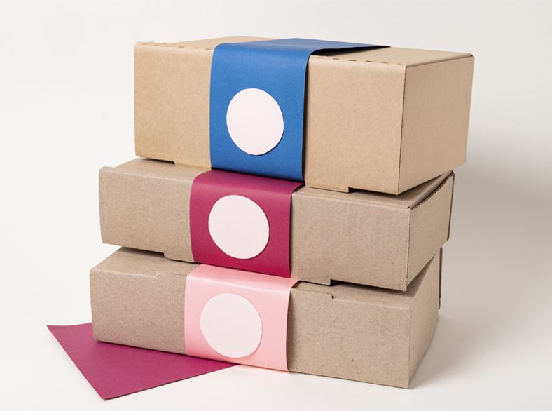 A woman is sitting at a table working on a machine.