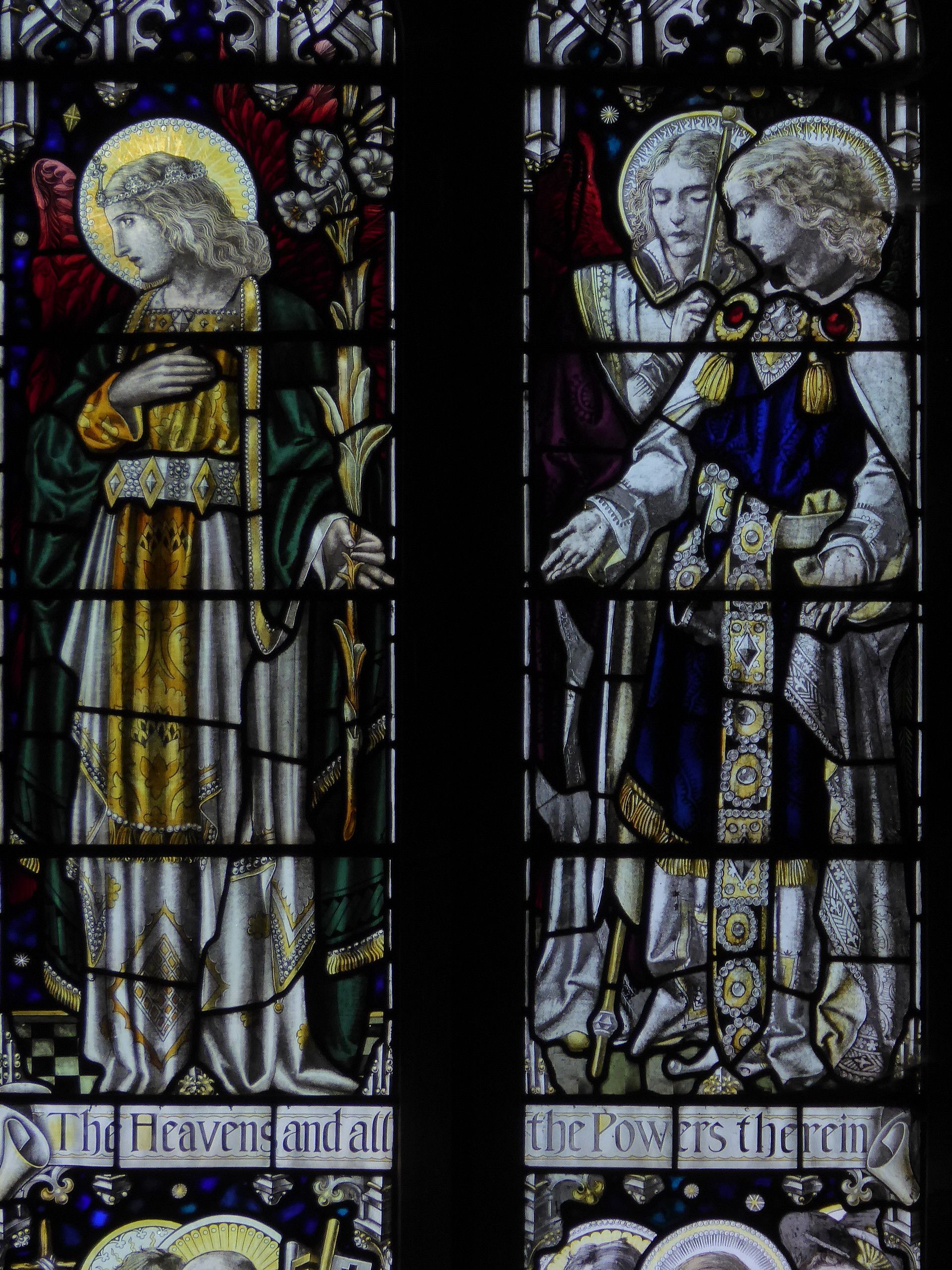 A stained glass window in a church shows angels