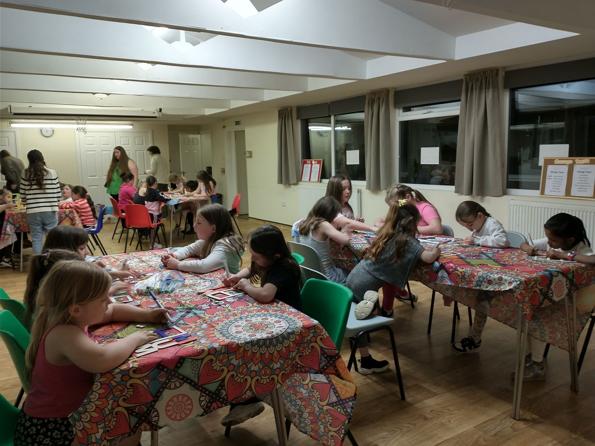 A large room with tables and chairs in it.