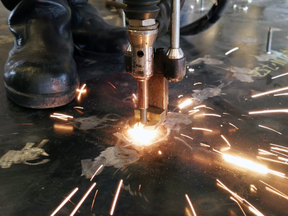 A Machine Is Cutting a Piece of Metal with Sparks Coming out Of It — Mayric Engineering in Old Bar, NSW