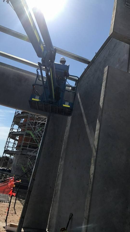 A Construction Worker Is Working on A Concrete Structure with A Crane — Mayric Engineering in Forster, NSW