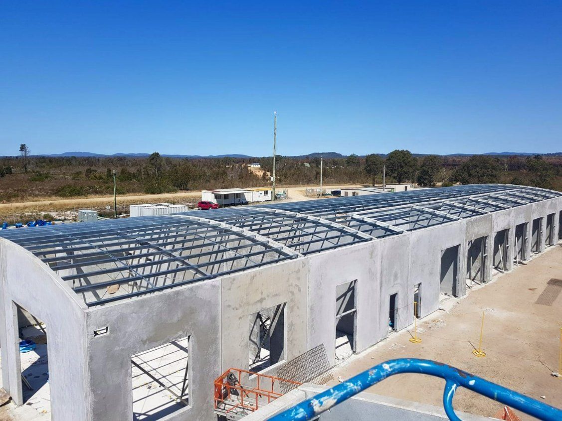 A Large Building Under Construction with A Blue Sky in The Background — Mayric Engineering in Forster, NSW