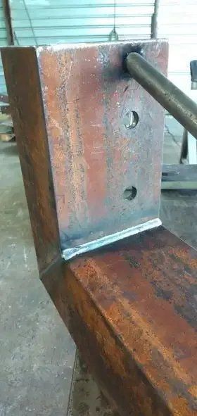 A Piece of Metal Is Sitting on Top of A Wooden Table — Mayric Engineering in Old Bar, NSW
