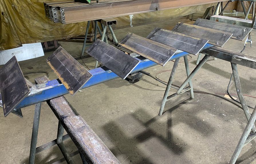 Bunch of Metal Pieces Are Sitting on Top of Each Other on a Table — Mayric Engineering in Taree, NSW