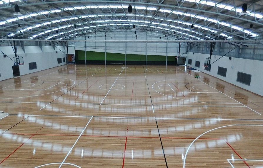Large Indoor Basketball Court With a Wooden Floor — Mayric Engineering in Taree, NSW