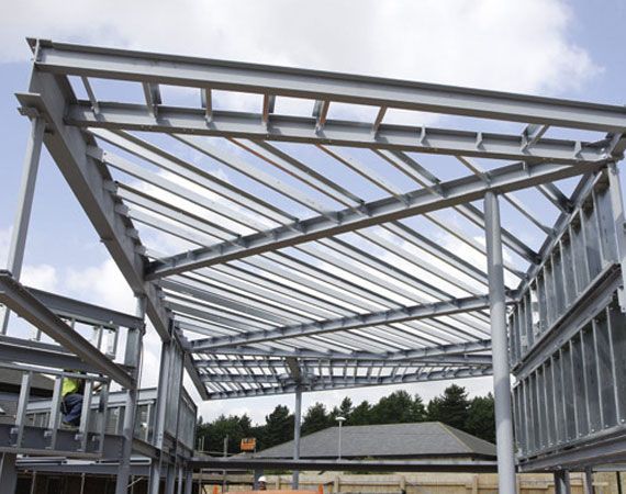 Large Metal Structure is Under Construction With a Blue Sky in the Background — Mayric Engineering in Taree, NSW