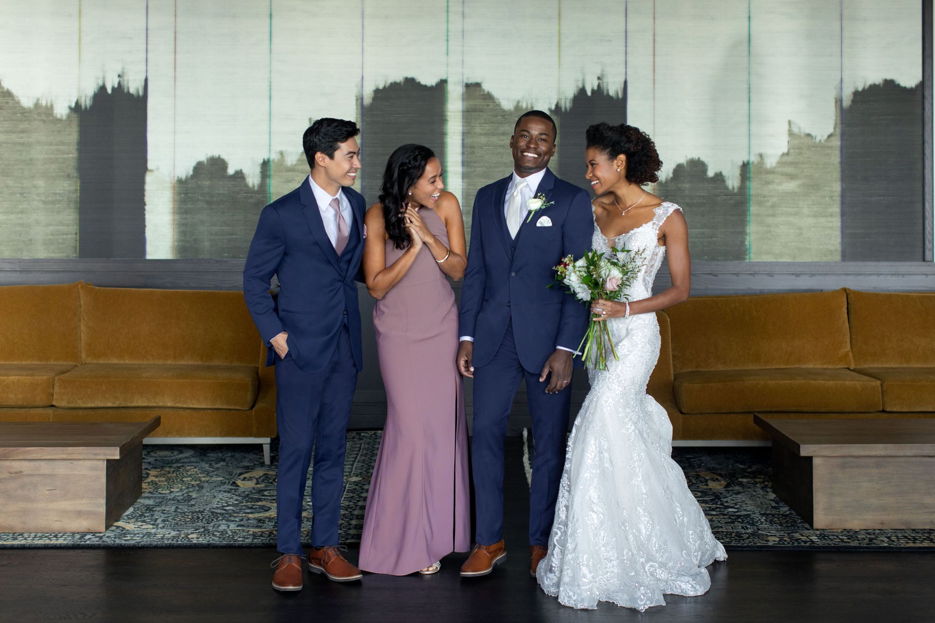 A bride and groom are posing for a picture with their wedding party.