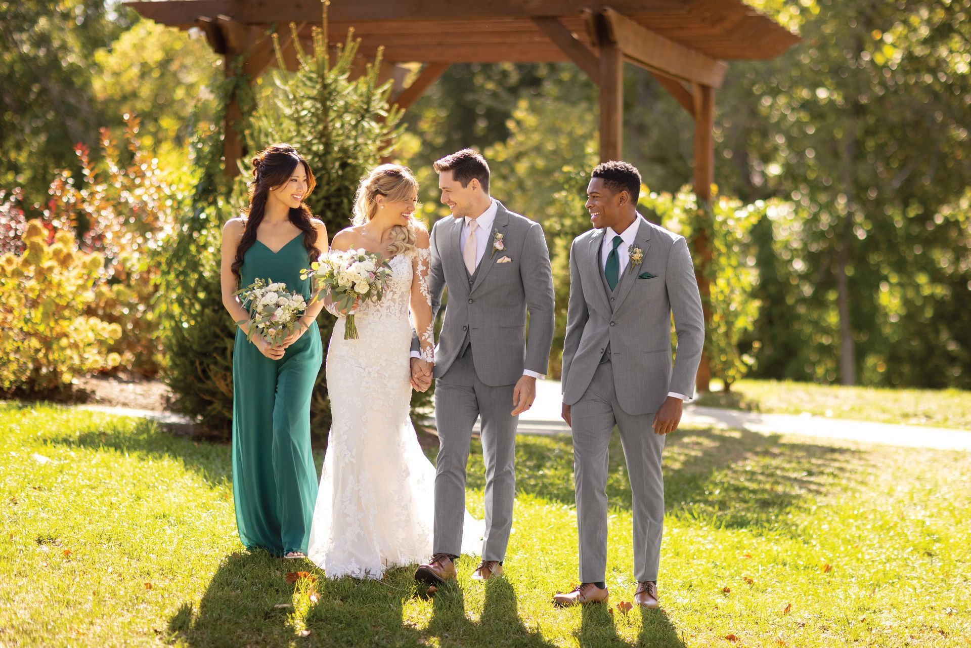 A bride and groom are posing for a picture with their wedding party.