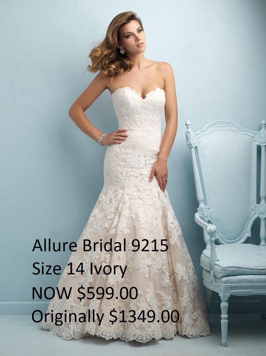 A woman in a white wedding dress is standing on a wooden floor.