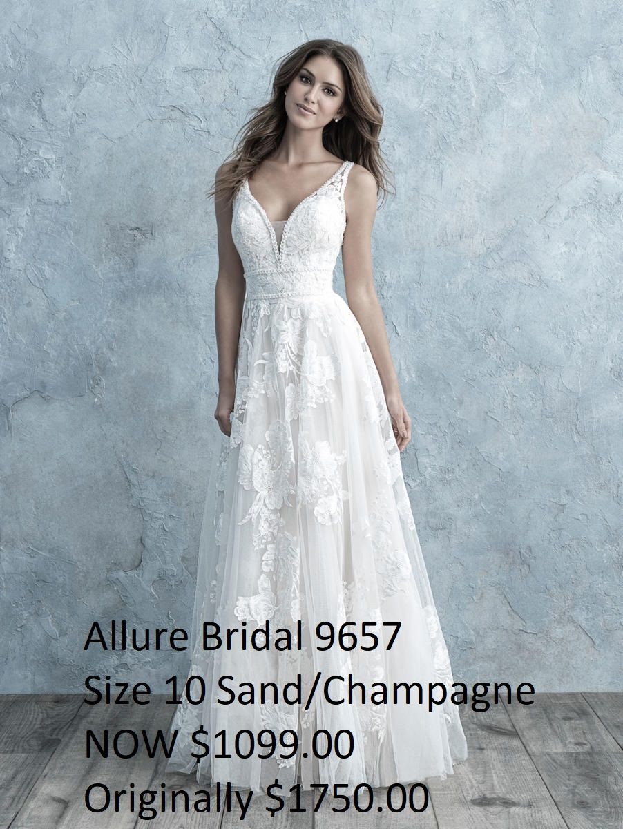 A woman in a white wedding dress is standing in front of a wall.