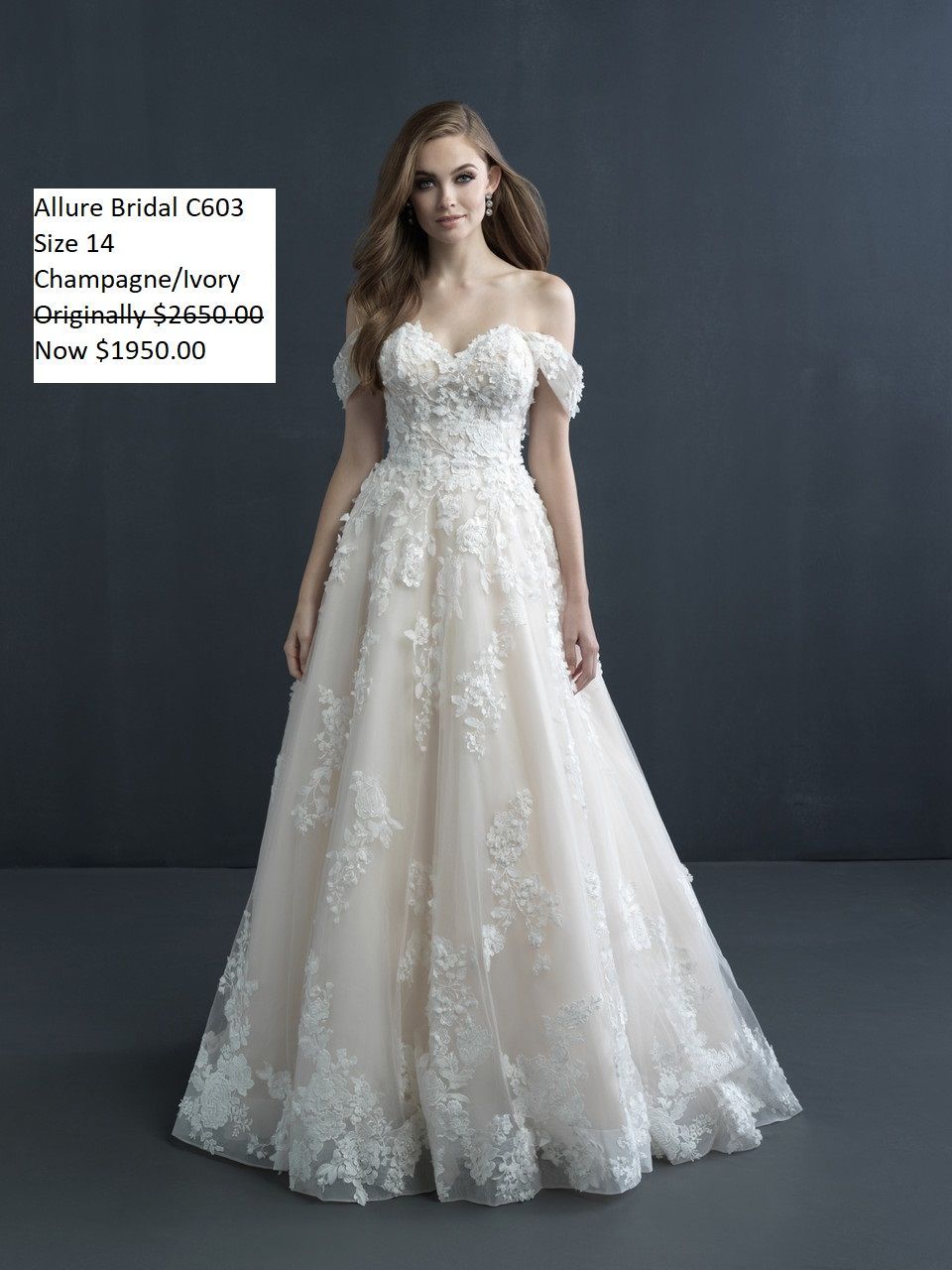 A woman is wearing a white lace wedding dress. Allure Couture C603