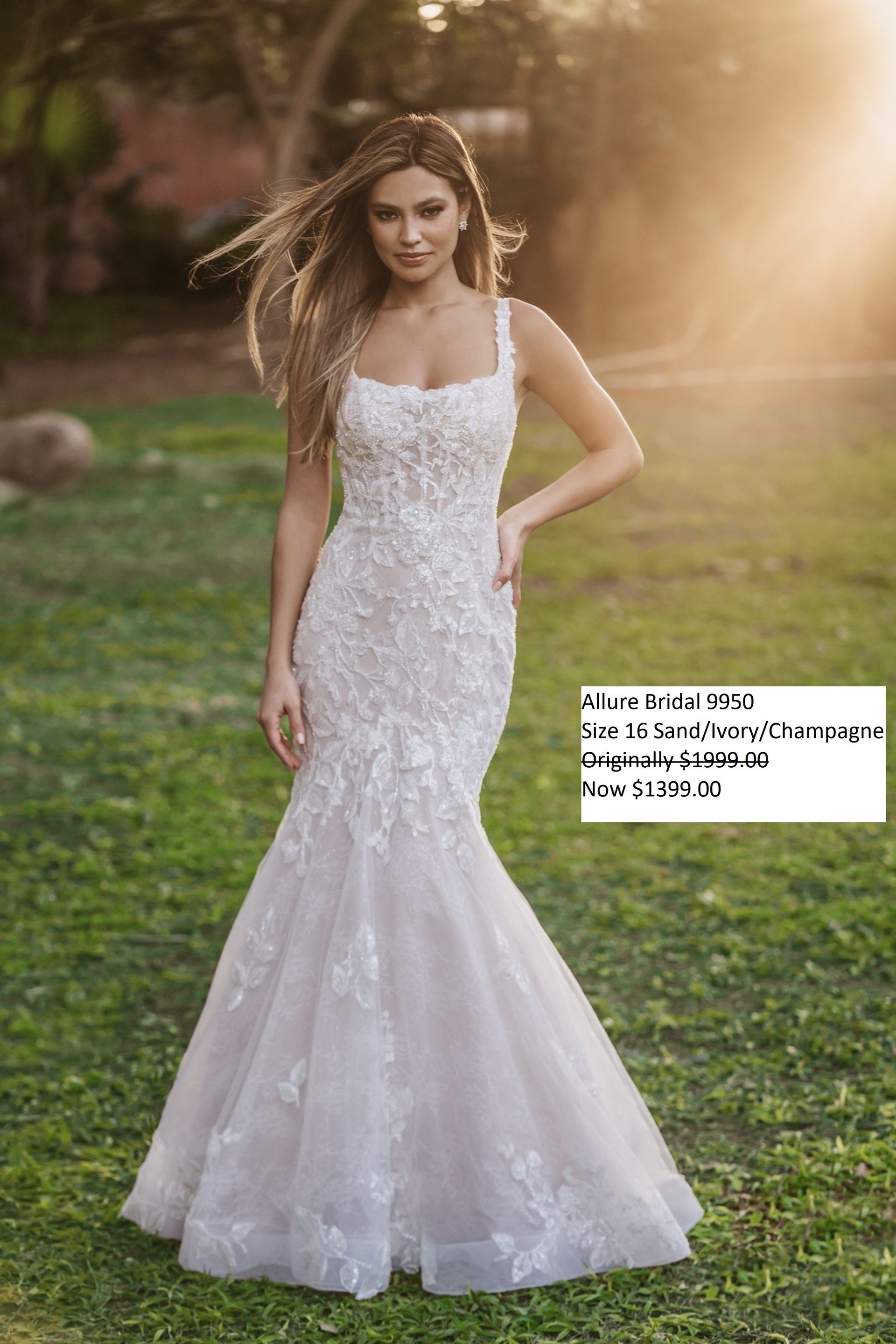 A woman in a white wedding dress is standing in the grass. Allure Bridal 9950