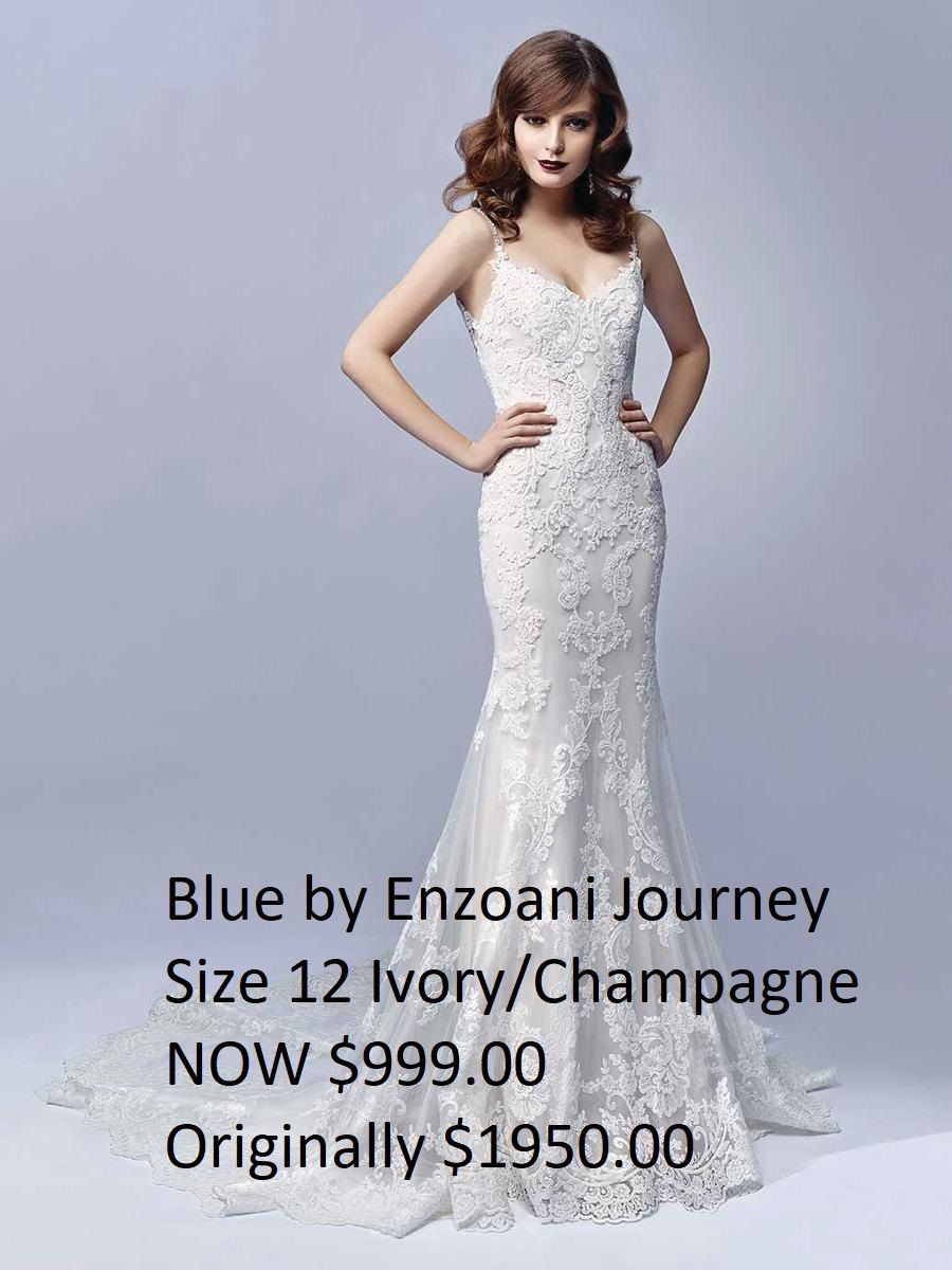 A woman is wearing a white lace wedding dress