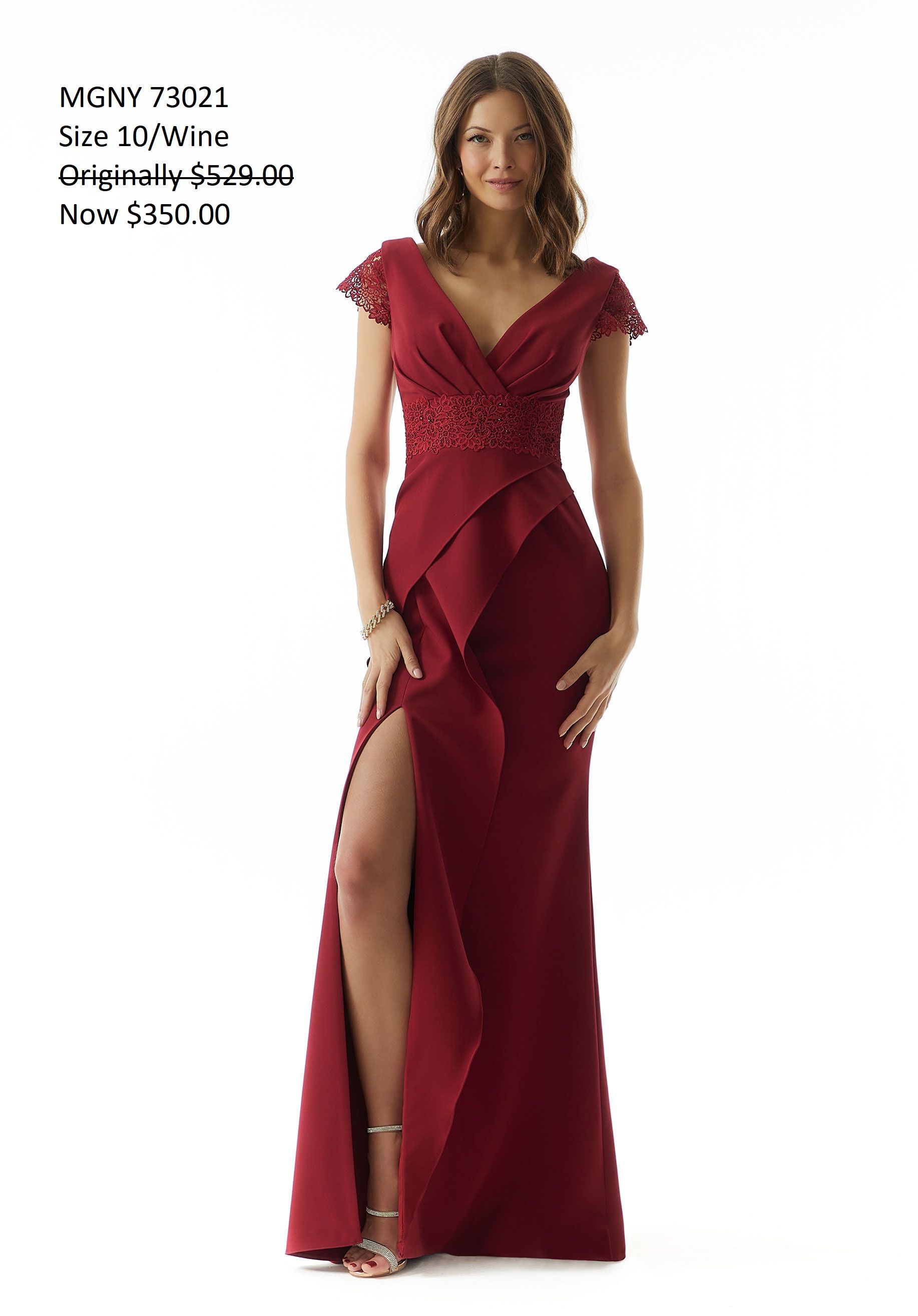 A woman is wearing a long red dress with a high slit.