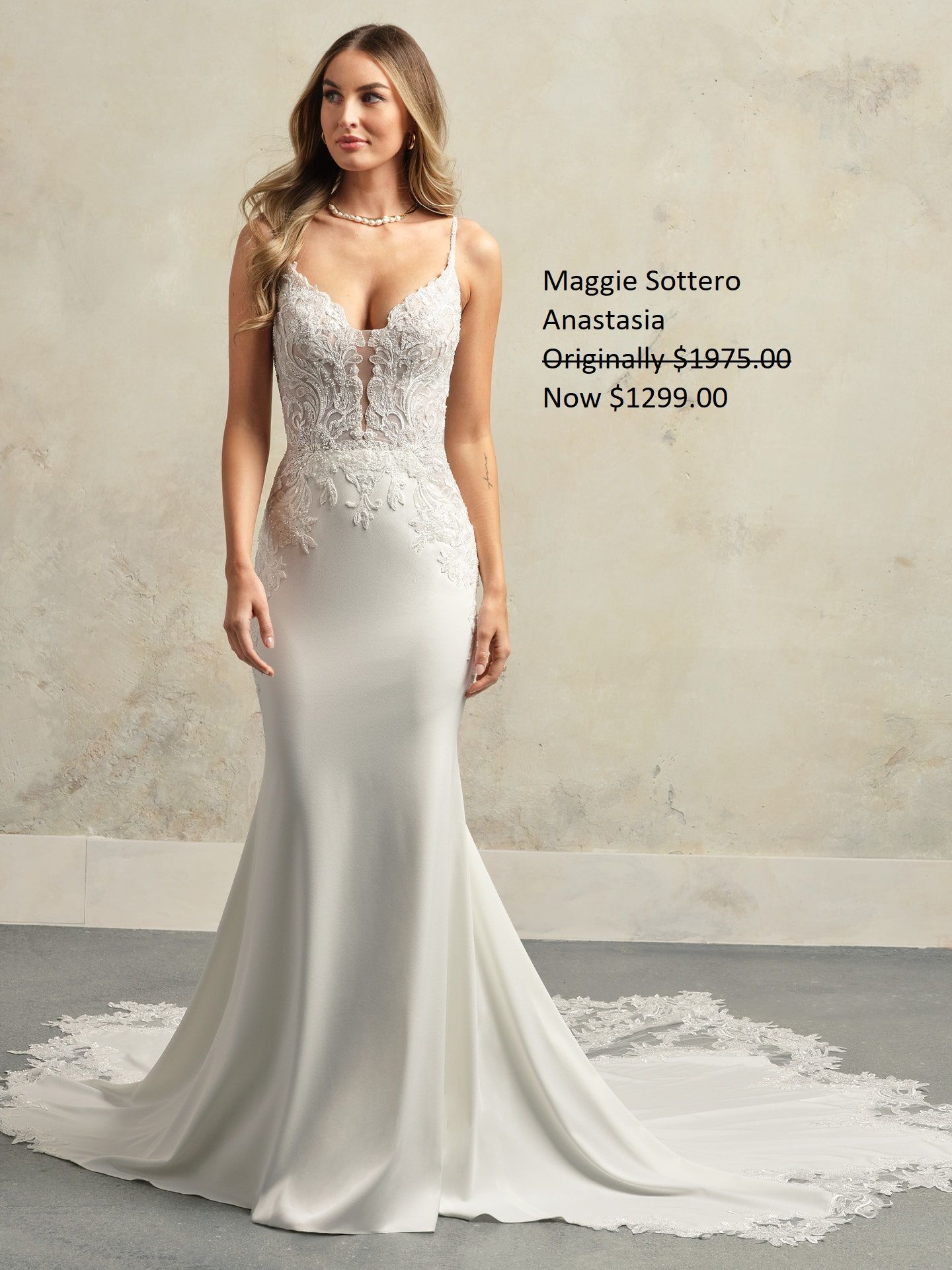 Woman in white Maggie Sottero Anastasia wedding dress with long train. Maggie Sottero Anastasia