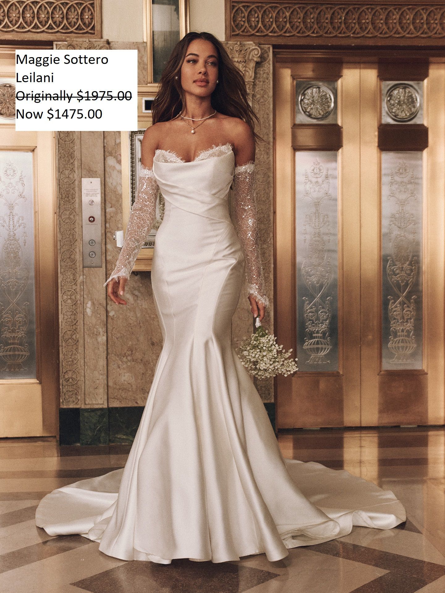 Woman in a white off-the-shoulder wedding dress with long lace sleeves. Standing in a gold-toned hallway. Maggie Sottero Leilani