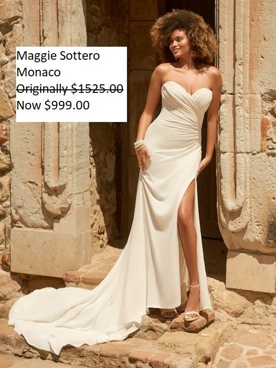 A woman is wearing a white strapless wedding dress with a high slit. Maggie Sottero Monaco