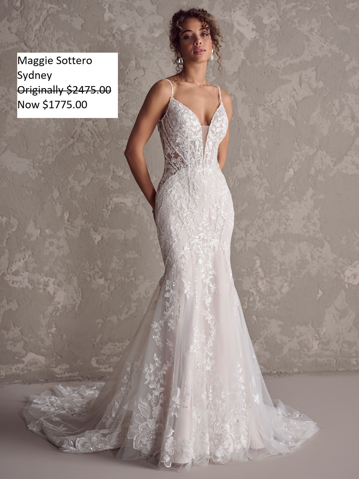 Woman wearing a white, lacy mermaid-style wedding gown; dress has a plunging neckline, thin straps and a train. Maggie Sottero Sydney