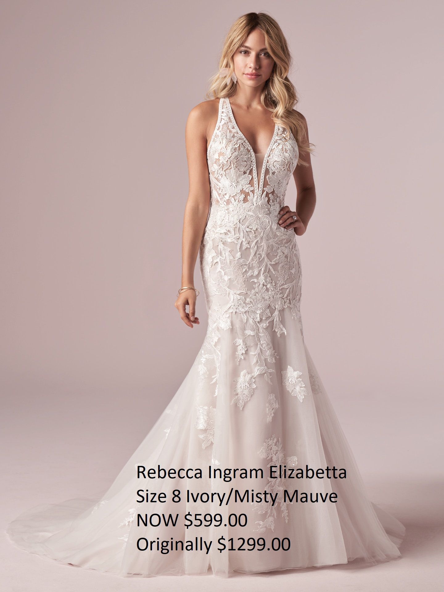 A woman is wearing a white wedding dress with a plunging neckline.