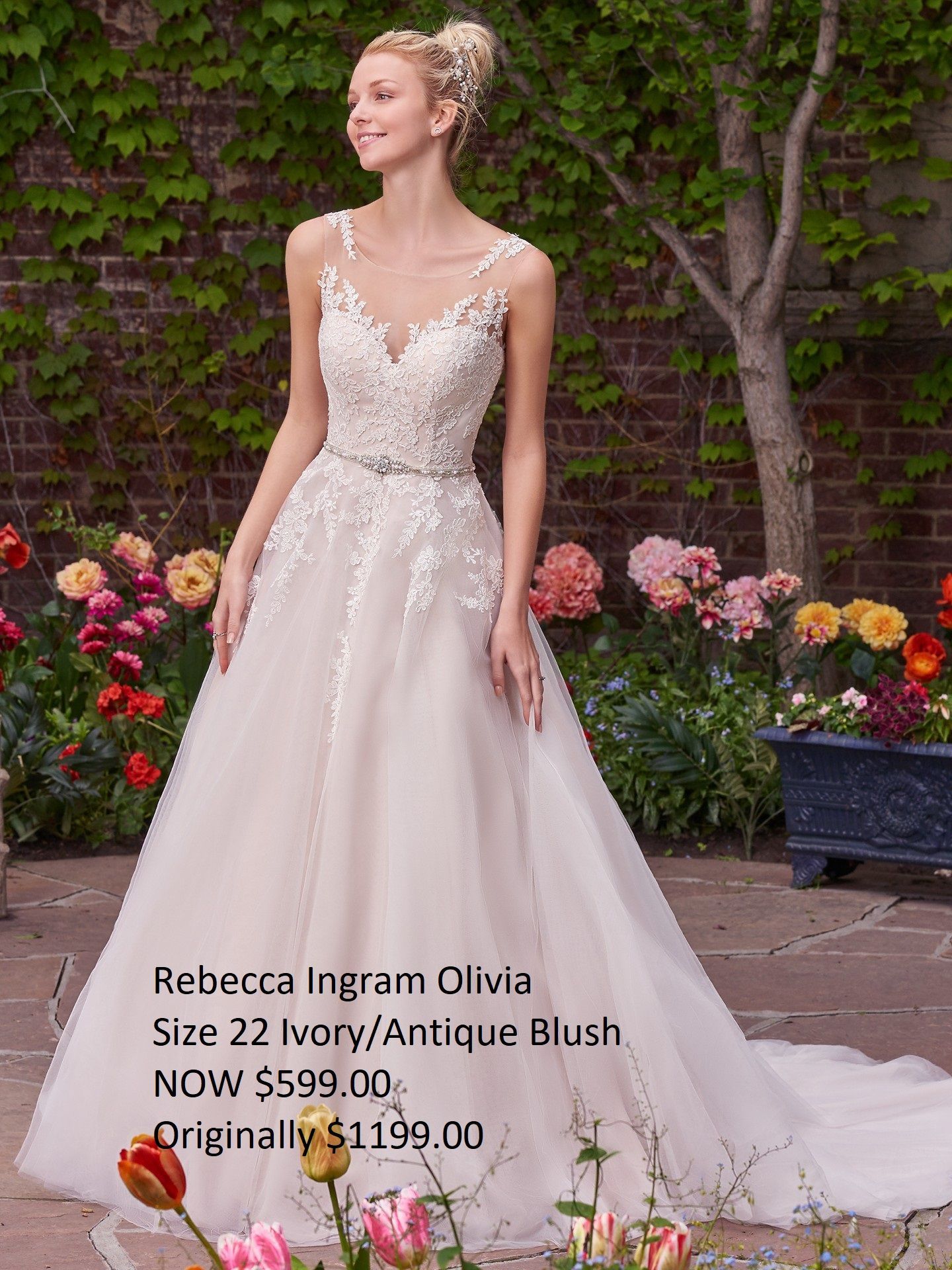 A woman in a wedding dress is standing in front of flowers.