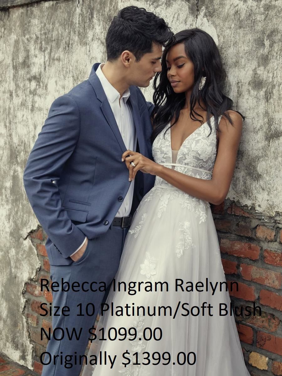 A man in a suit kisses a woman in a wedding dress