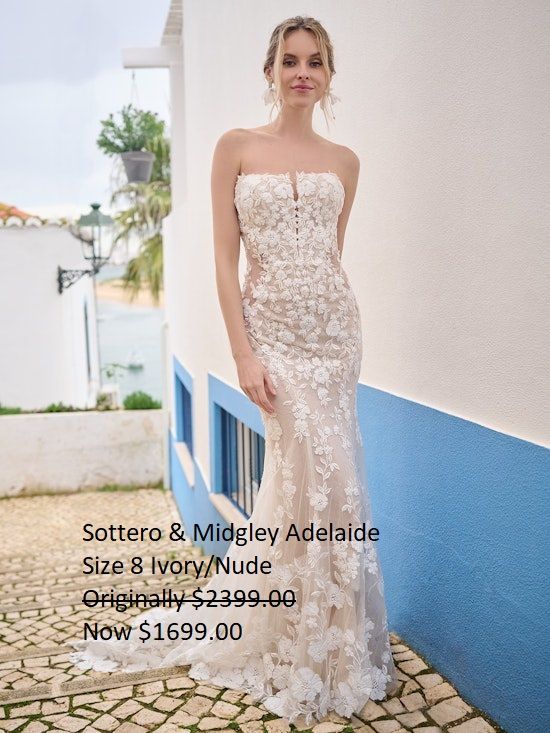 A woman in a wedding dress is standing in front of a building. Sottero & Midgley Adelaide