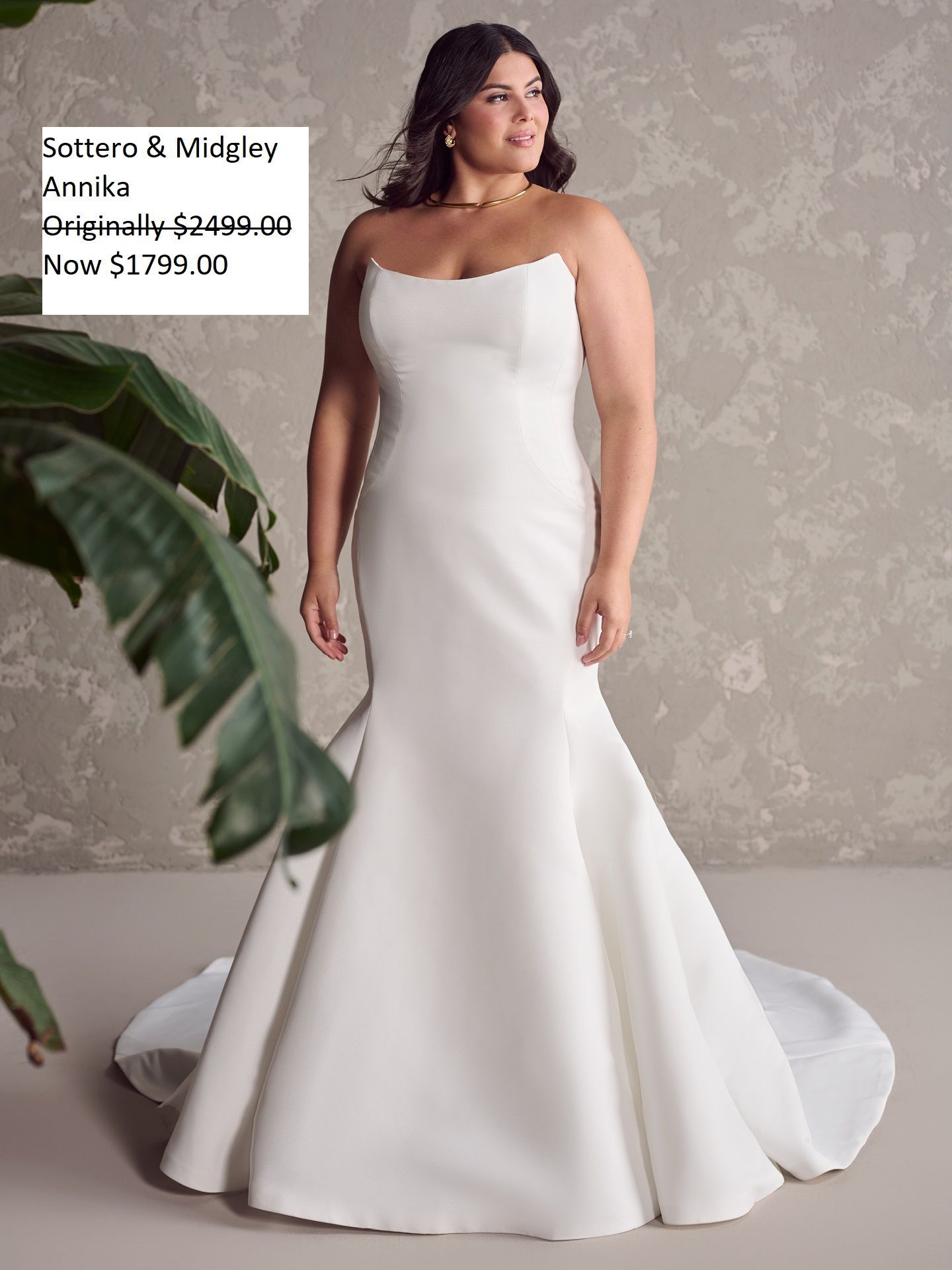 Woman wearing a strapless white mermaid-style wedding dress, standing indoors. Sale price displayed. Sottero & Midgley Annika