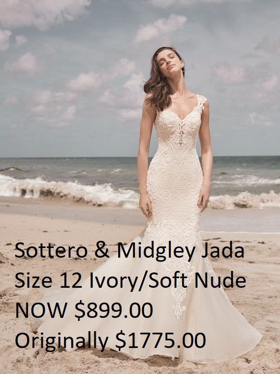 A woman in a wedding dress is standing on a beach.