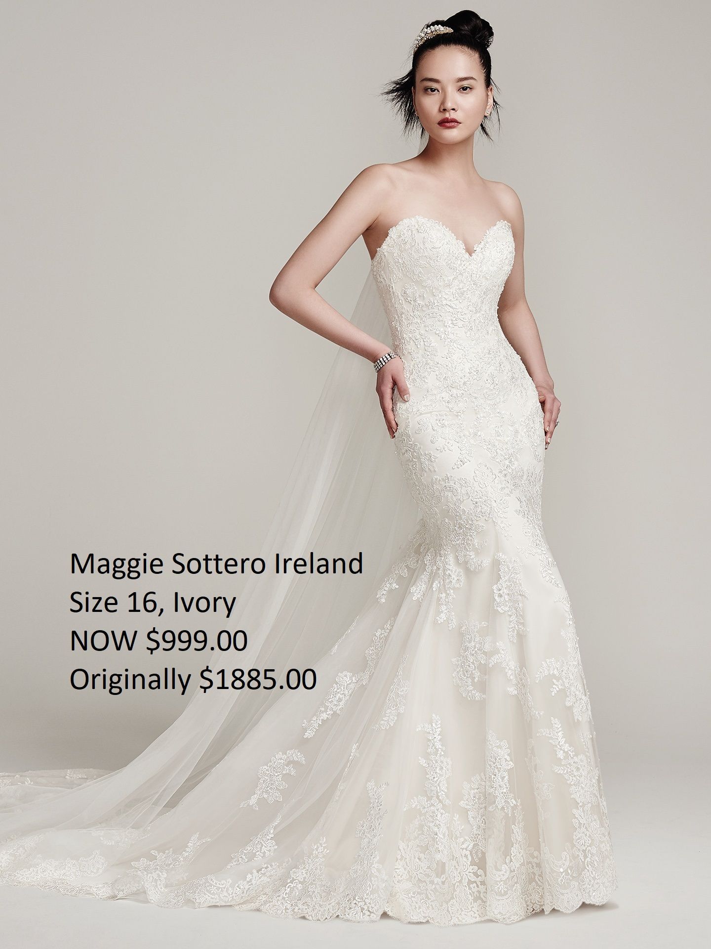 A woman is wearing a white lace wedding dress