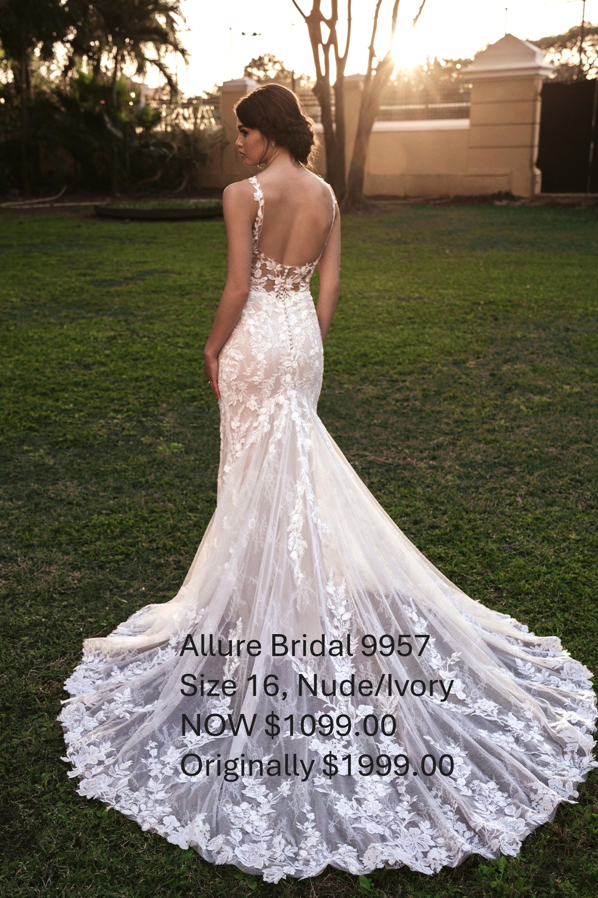 A woman in a wedding dress is standing in a grassy field. Allure Bridal 9957