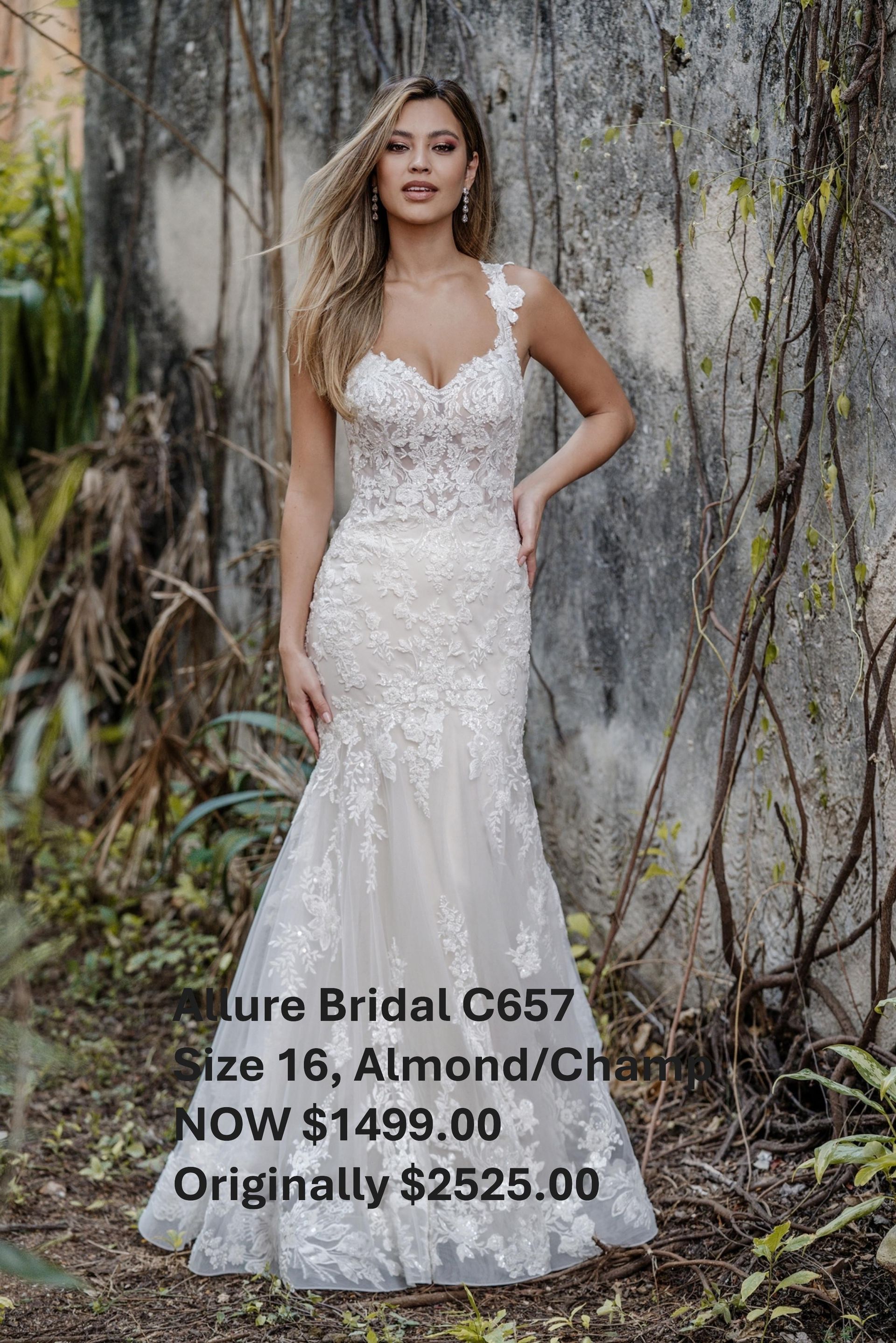A woman in a white wedding dress is standing in front of a wall. Allure Bridal C657