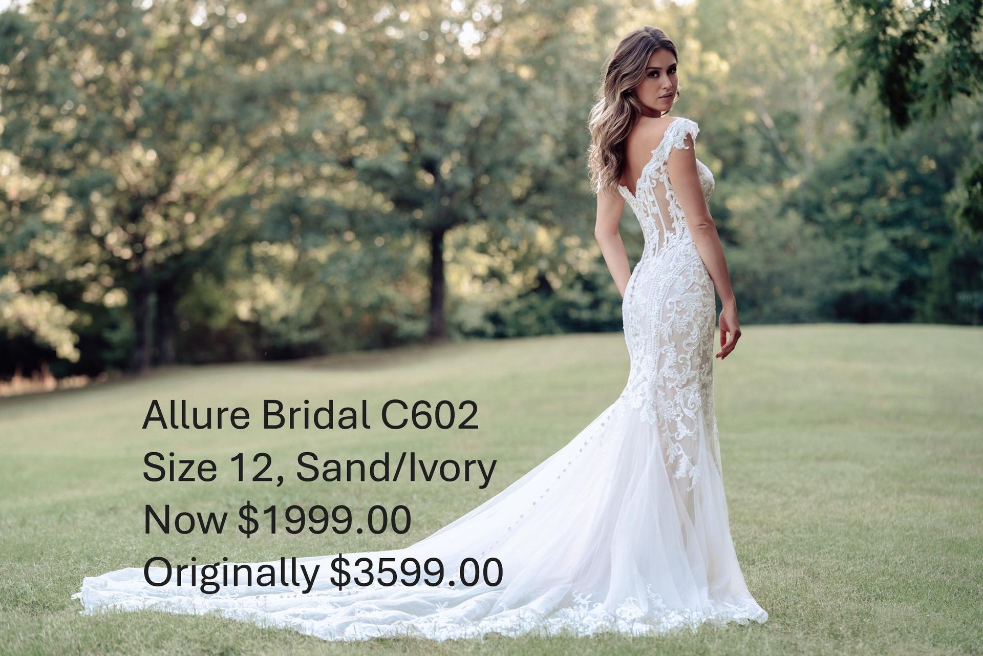 A woman in a white wedding dress is standing in a grassy field. Allure Brdial C602