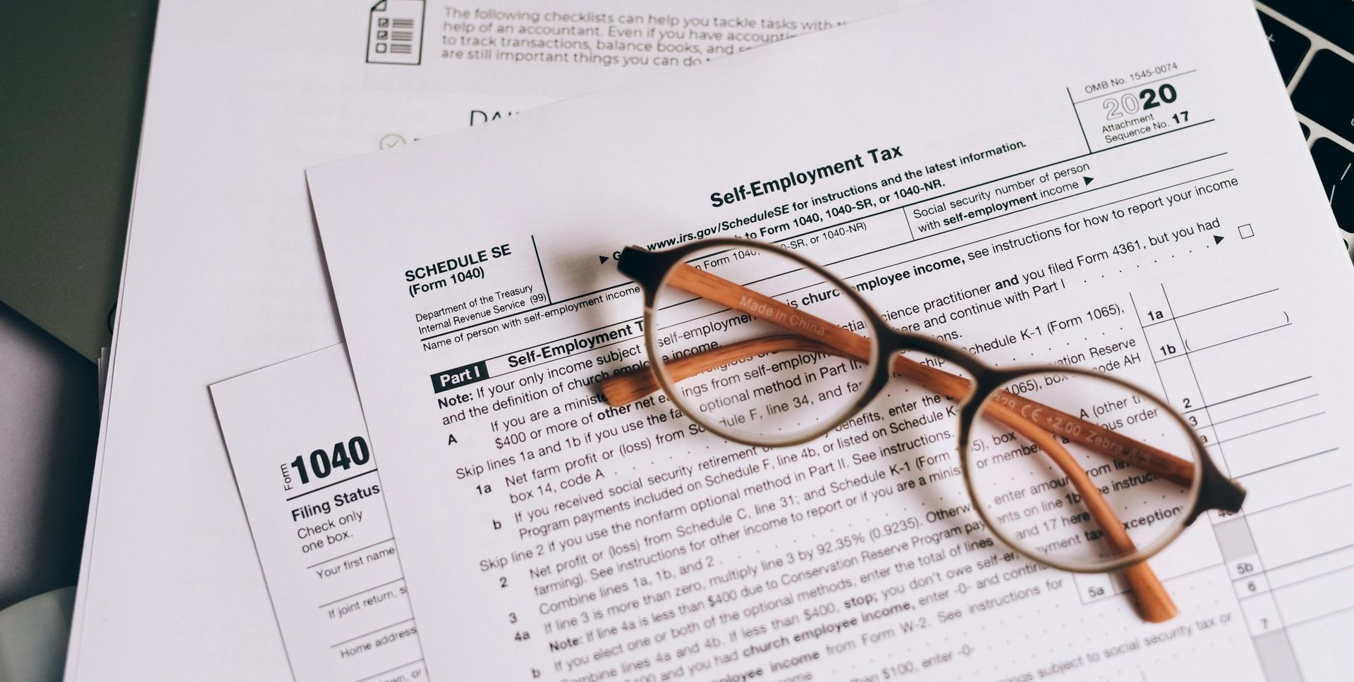 A pair of glasses is sitting on top of a tax form.