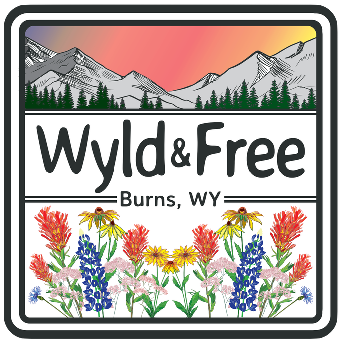 Square logo: Mountains, sunset, wildflowers, text 