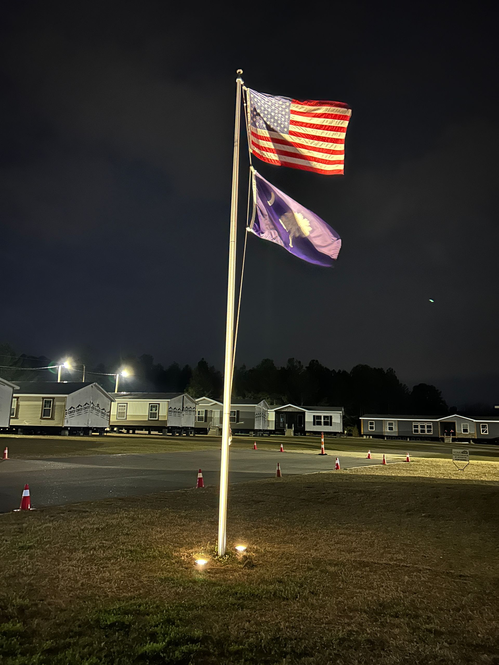 Sign for Rev Auto Tires & Brakes. Features logo, phone number, and