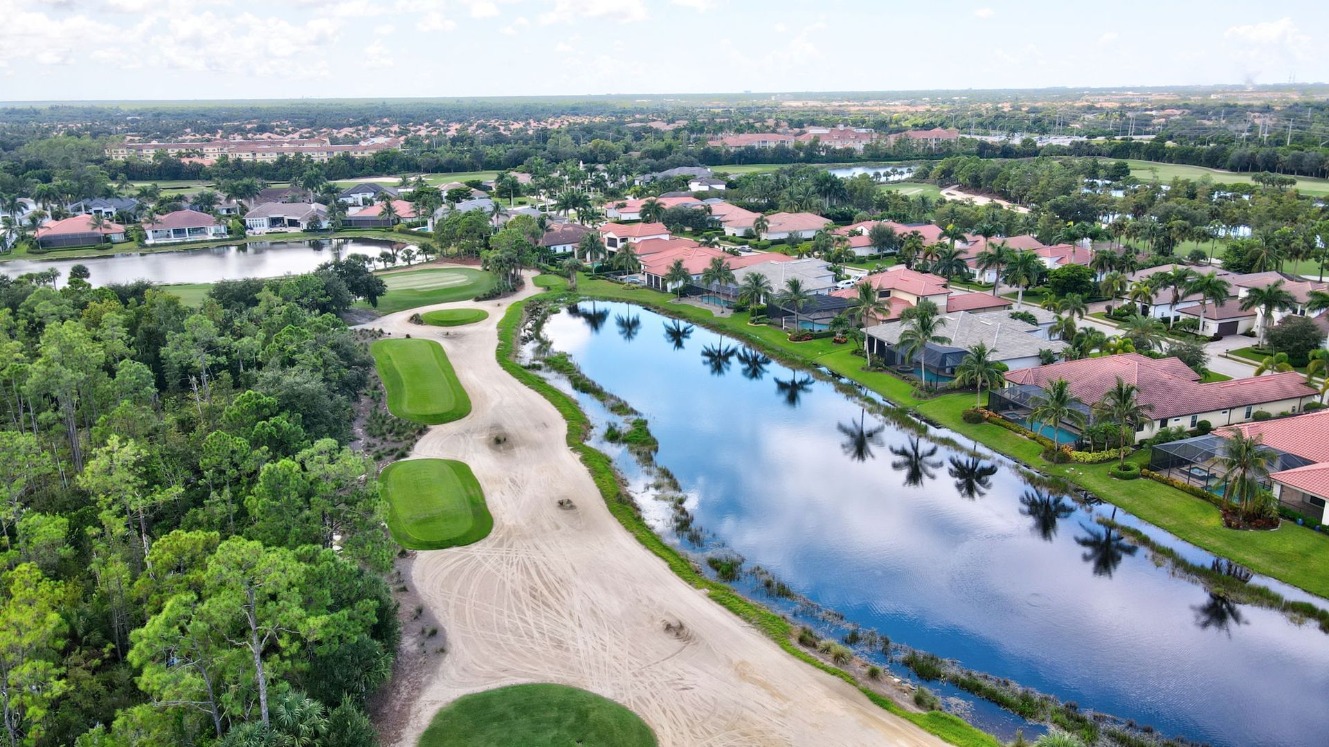 A patio with a lot of furniture and lights at night.