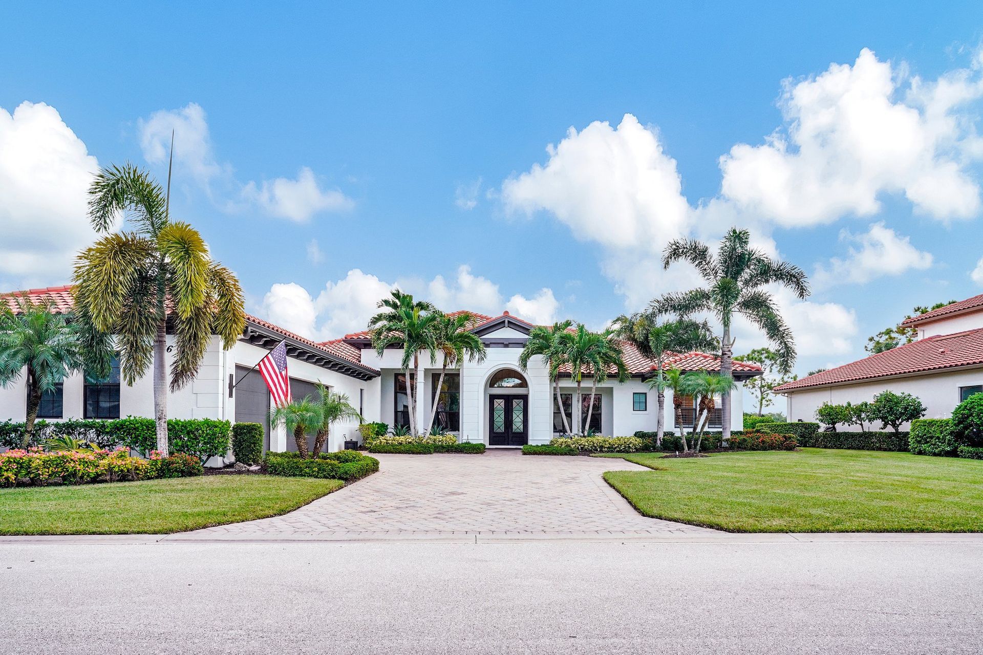 A dining room with a table and chairs and a wooden staircase.
