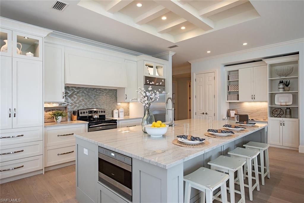 A vase of flowers is sitting on a table next to a window.