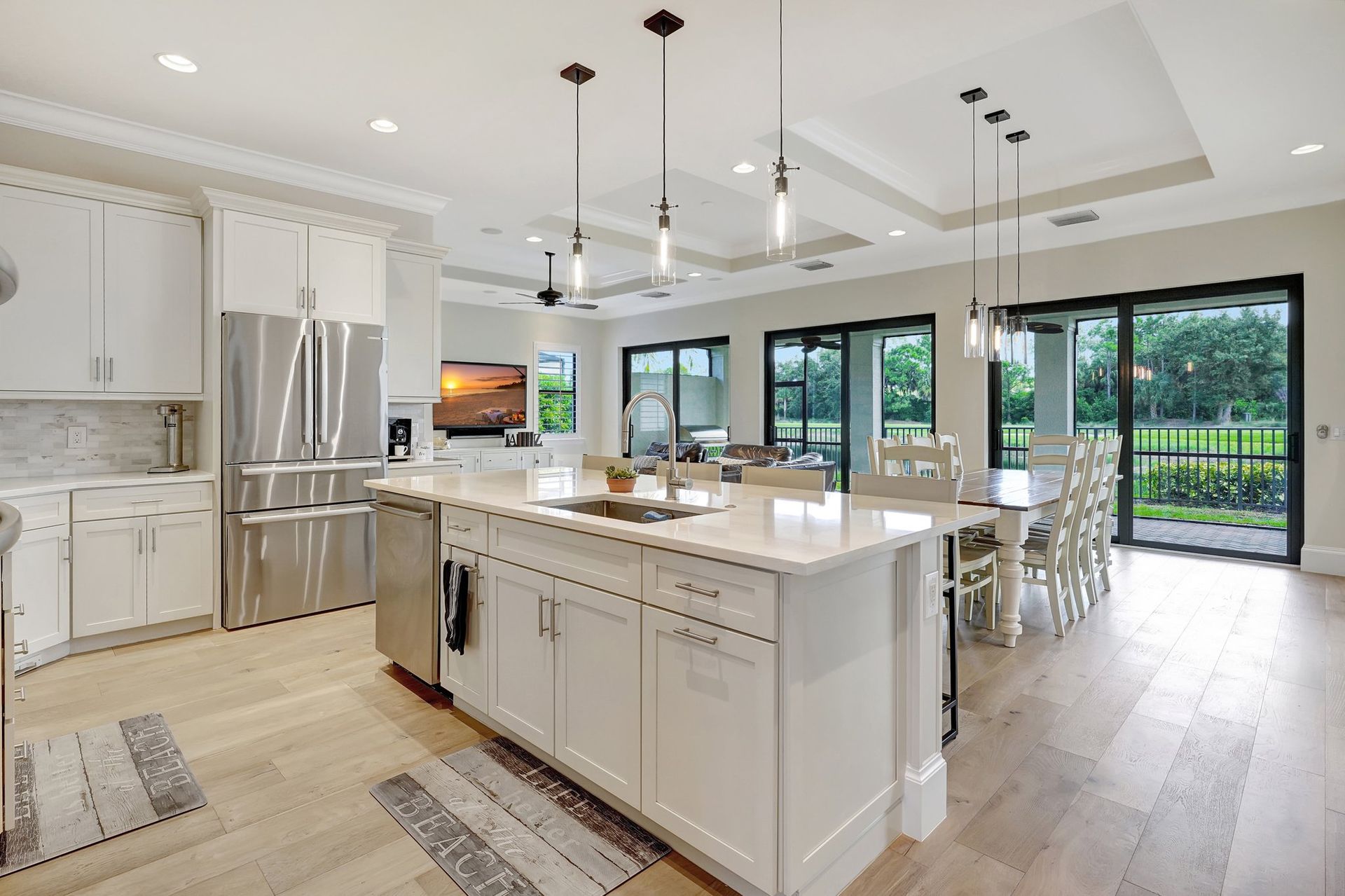 A living room with a couch , chairs , ottoman and a mirror