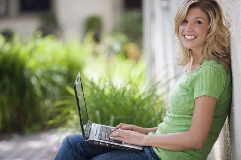 woman on laptop computer in garden