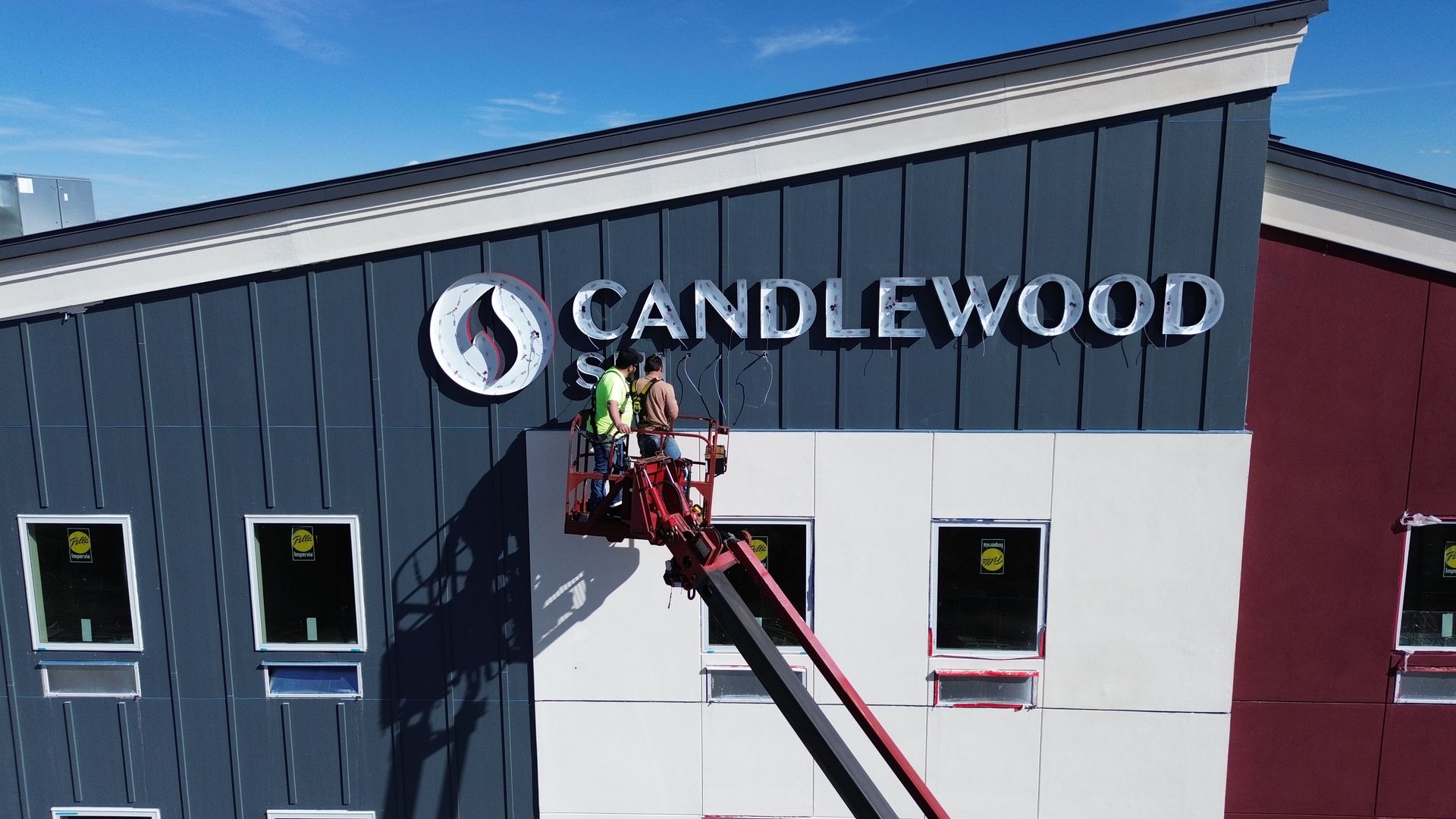 Workers on a lift installing a 