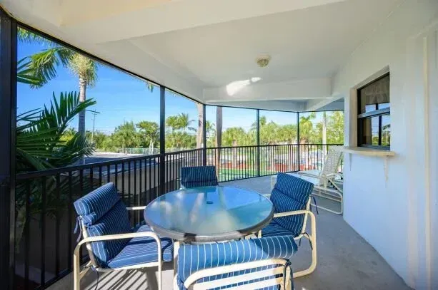view from Tropical Garden villa balcony to tennis courts at Coco Plum Beach and Tennis Club and Marina in the Florida Keys
