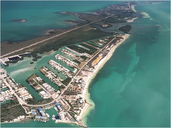 high aerial view of property island inlet location for Coco Plum Beach and Tennis Club and Marina in the Florida Keys